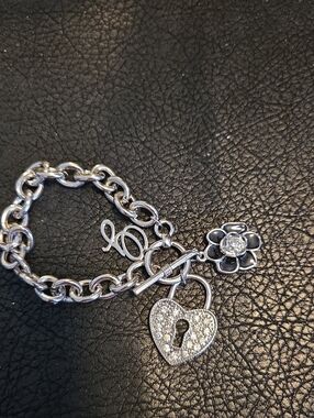Guess Silver Tone Heart Lock Charm Bracelet with Flower With Black Enamel Accent
